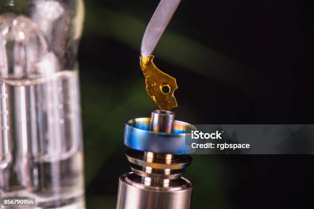 Dabbing Tool With Small Piece Of Cannabis Oil Aka Shatter Medical Marijuana Concentrates Concept Stock Photo - Download Image Now