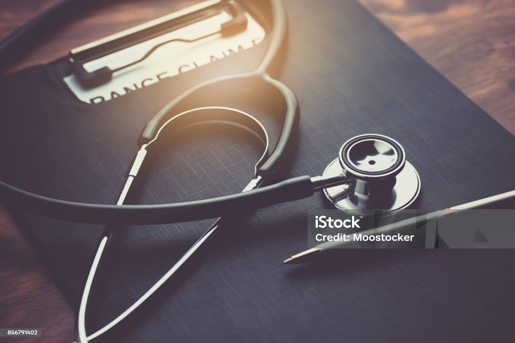 health insurance claim form with stethoscope on wood table selective focus Healthcare And Medicine Stock Photo