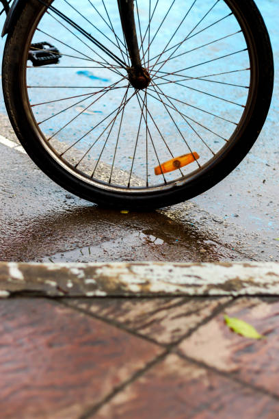 istock rainy day, closeup old bicycle with soft-focus and over light in the background 856794232