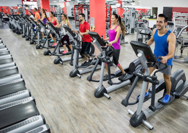 istock People at the gym exercising on cross trainers 856794454