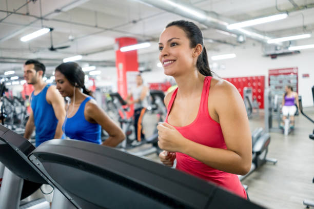 istock People exercising at the gym running on the treadmills 856794746