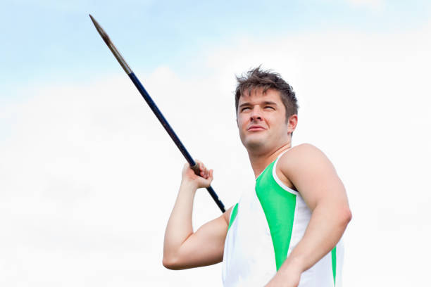 istock Handsome male throwing a javelin outdoors 856797658