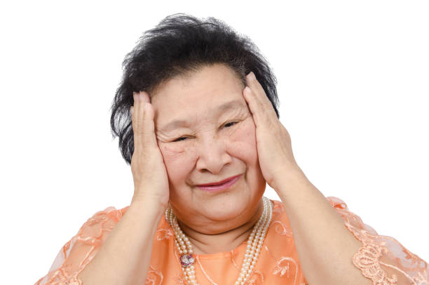 istock Asian elderly woman with headache over white background 856797974