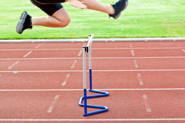 istock Assertive male athlete jumping above hedge during a race 856798320