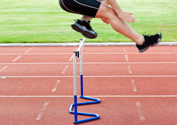 istock Selfassured male athlete jumping above hedge during a race 856798338
