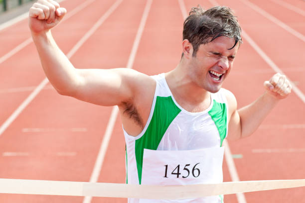 istock Exulting sprinter showing expression of victory in front of the arrival line 856798358