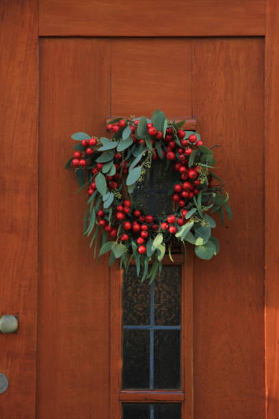 istock Berry christmas wreath with decorations on a door 856801382