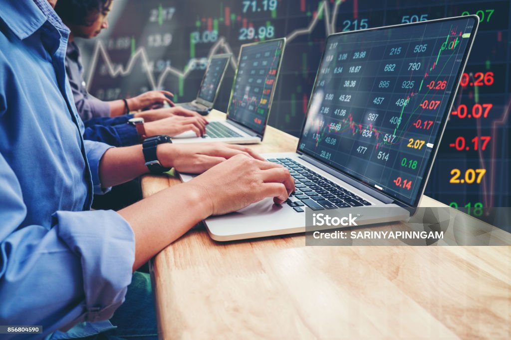 Business Team Investment Entrepreneur Trading working on Laptop Stock market exchange information and Trading graph Currency Exchange Stock Photo