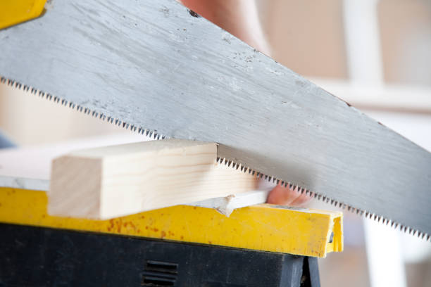 istock Close up of a worker sawing a board 856804686