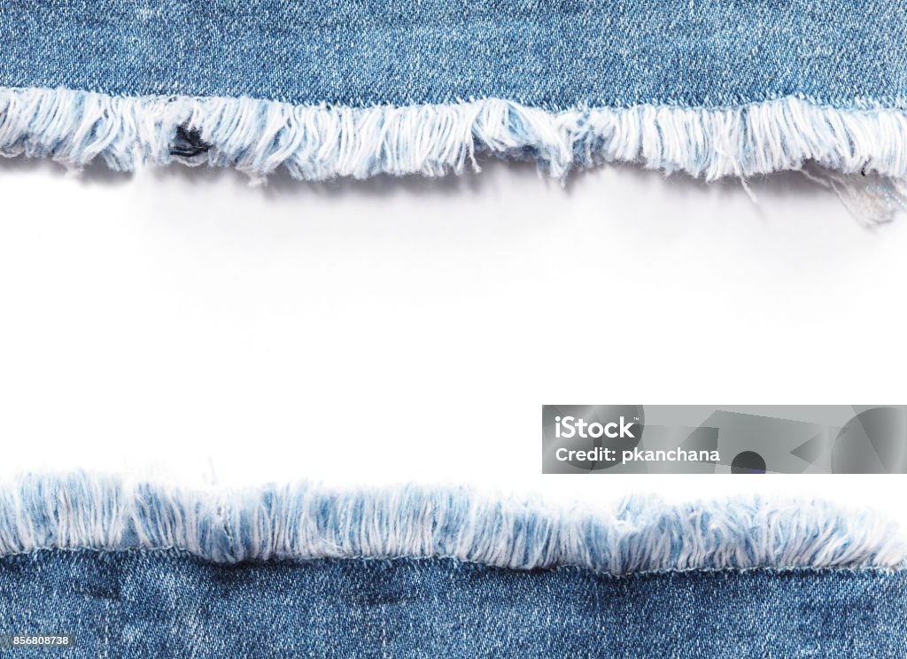 Edge frame of blue denim jeans ripped destroyed torn over white background. Jeans Stock Photo