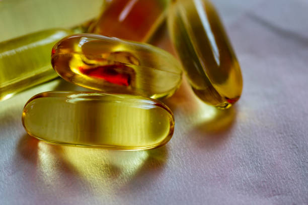 istock Fish oil capsule close up on tissue background 856811704