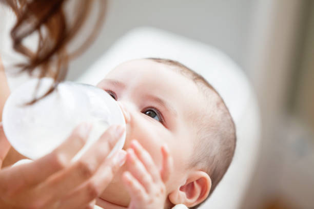 istock Positive mother feeding her adorable son in the kitchen 856811756