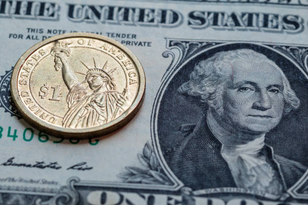 istock US dollar cash banknote and coin background close up 856811812