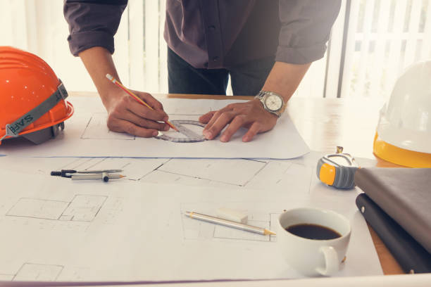 istock Architect concept, Architects working with blueprints in the office, Vintage Effect 856811854