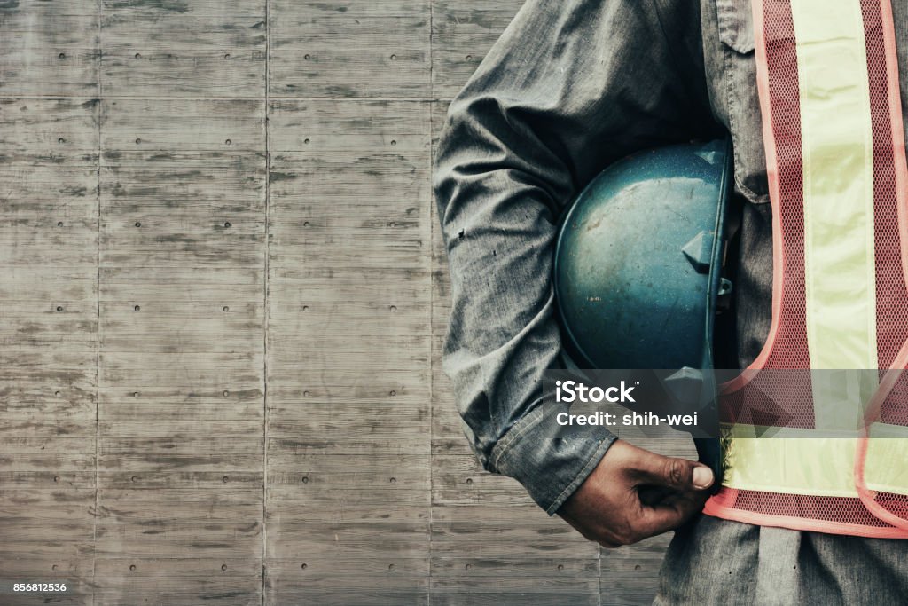 construction worker checking location site with crane on the background Blue-collar Worker Stock Photo