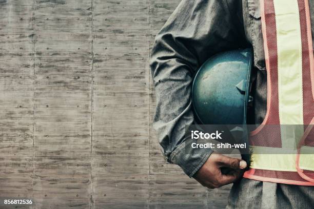 Construction Worker Checking Location Site With Crane On The Background Stock Photo - Download Image Now