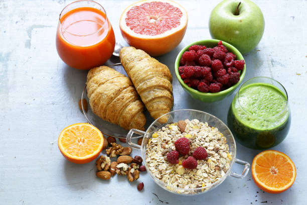 istock A healthy breakfast with croissants, fresh juice, nuts and raspberries 856819300
