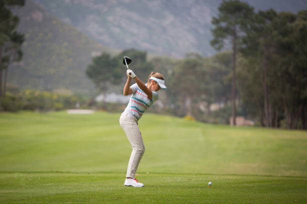 istock Young blond woman hitting the golf ball 856820068