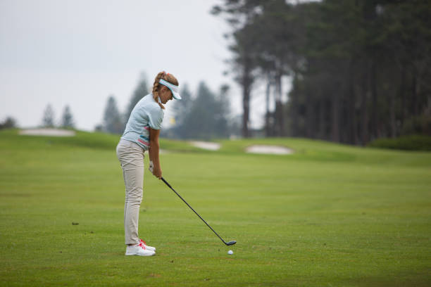 istock Beautiful blond woman hitting the golf ball 856820600