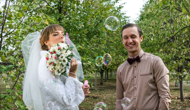 istock Cheerful bride and groom in the autumn park 856823408