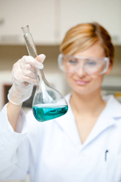 istock Portrait of a bright female scientist looking at a liquid 856827480