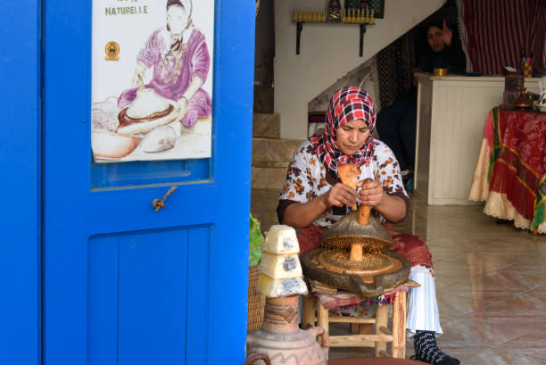 Moroccan woman make argan oil in Essaouira. Morocco Essaouira, Morocco - January 01, 2017: Moroccan woman make argan oil on the market in medina moroccan woman stock pictures, royalty-free photos & images