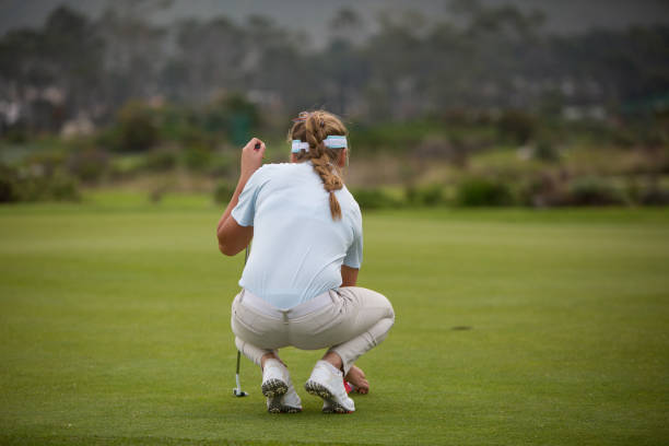 istock Blond woman lining up her putt 856834152