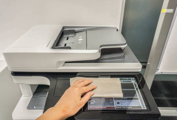 istock close up people clean touch screen of office printer for maintenance 856837602