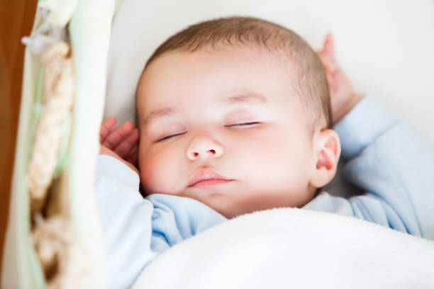 istock Portrait of a sleeping baby lying in his cradle 856845982
