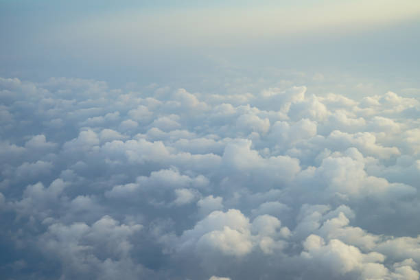 istock View of beautiful dreamy fluffy abstract white cloud with blue sky and sunrise light background from airplane window 856849724