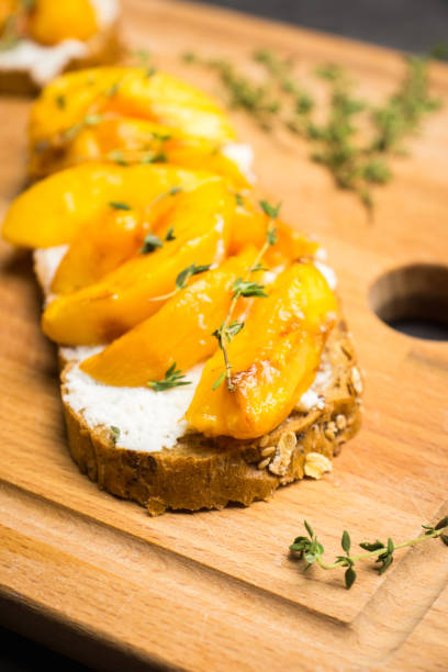 istock Bread with ricotta cheese and grilled peaches on the rustic background 856854154