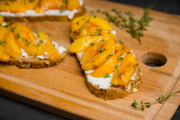 istock Bread with ricotta cheese and grilled peaches on the rustic background 856854164