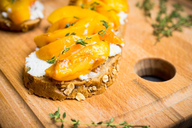 istock Bread with ricotta cheese and grilled peaches on the rustic background 856854190