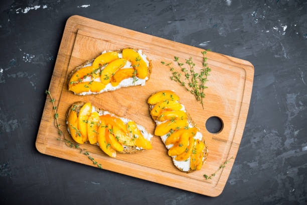 istock Bread with ricotta cheese and grilled peaches on the rustic background 856854220