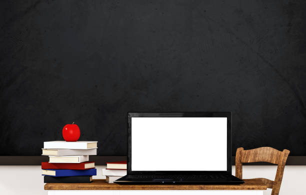 istock Laptop computer blank white screen, on wooden table in classroom 856854554