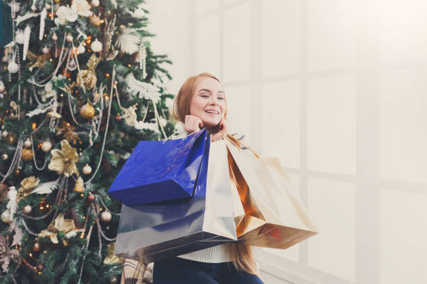istock Young woman with packages in holiday interior 856857196