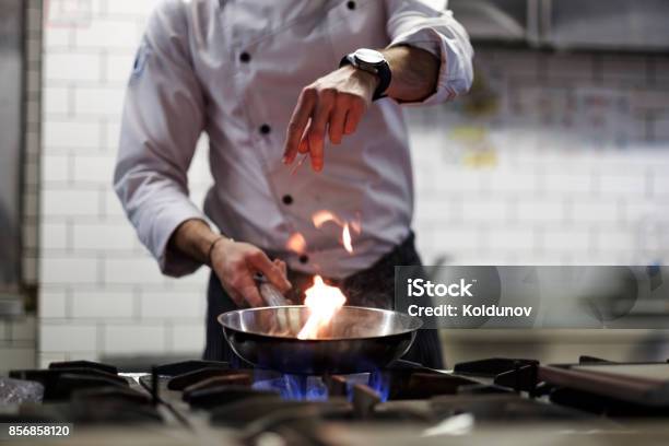 A Man Cooks Cooking Deep Fryers In A Kitchen Fire Stock Photo - Download Image Now - Chef, Cooking, Restaurant