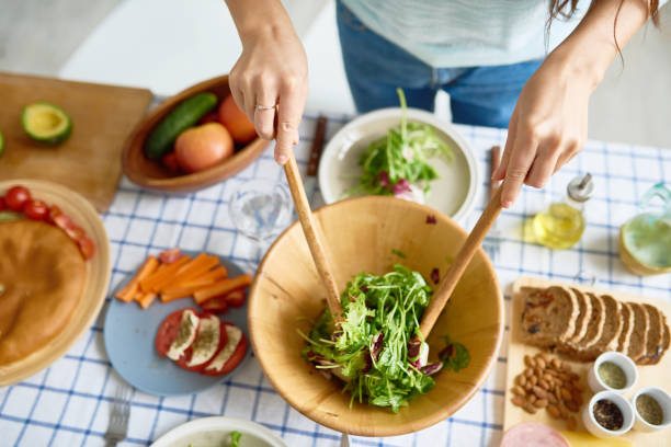 istock Young Woman Mixing Salad 856858634