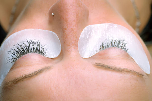istock Eyelash extension procedure, woman eye with Long eyelashes 856859152