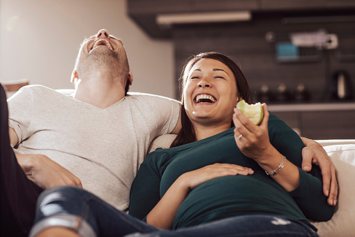 Young couple laughing and having fun at home