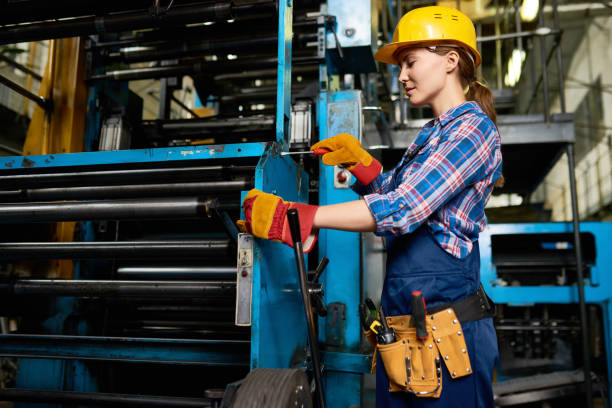 istock Young Woman Operating Machine Units in Workshop 856865426