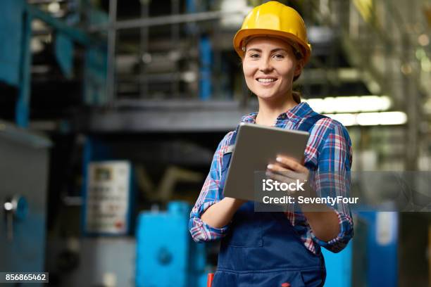 Beautiful Young Woman Working At Modern Plant Stock Photo - Download Image Now - Manufacturing Occupation, Women, Factory