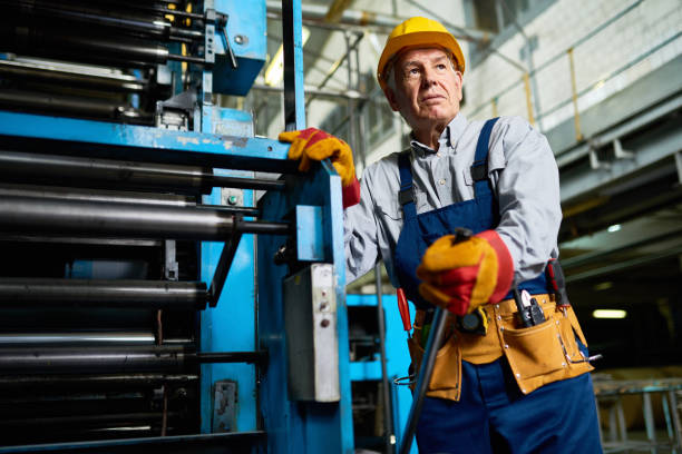 istock Senior Worker operating Machines at Factory 856865494