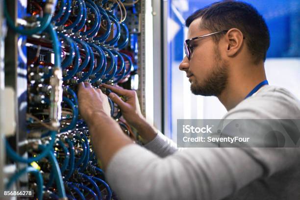 System Administrator Checking Servers Stock Photo - Download Image Now - Cable, Technology, Repairing