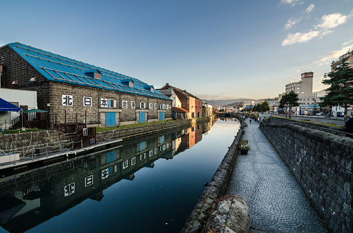 Otaru, Japan- 13 NOV 2015: Otaru Canal was once a central part of the city's busy port in the first half of the 20th century. Now, fanked by restaurants, shops & vendors, this historic canal has a romantic, old-timey ambiance.