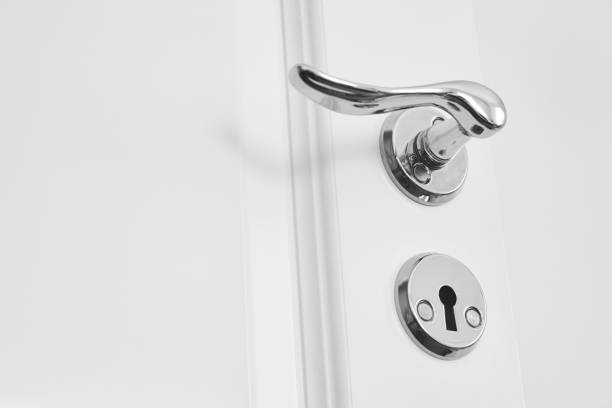 istock Metallic classic door knob on white door. Open closed 856872638