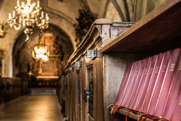 istock Row of psalm books in ancient church. 856880982