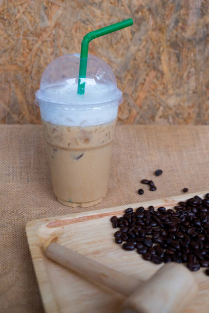 istock Iced coffee with coffee beans on wooden table 856881394