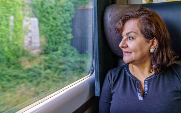 istock Attractive senior hispanic woman travelling on train 856881602