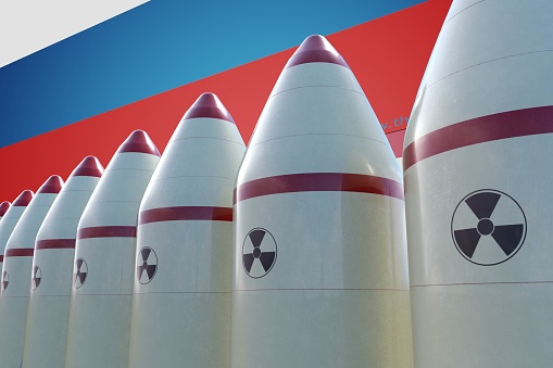 Nuclear missiles and Russian flag in background. 3D rendered illustration.
